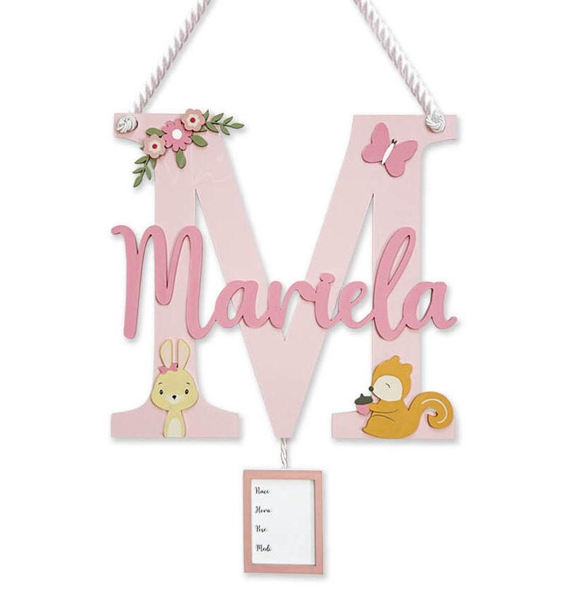 Decorative pink monogram wall plaque: large letter M with a script name 'Marla', floral accents, animal illustrations, and a hanging frame.