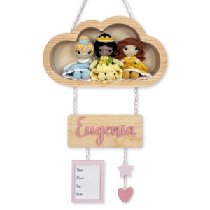 Wooden cloud wall hanging with three crocheted princess dolls and a pink name plaque reading 'Eugenia' for a nursery decor sign.