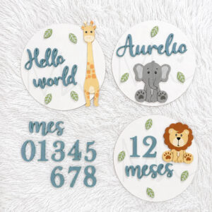 Three round milestone signs for a baby: Hello world with a giraffe; Aurelio with an elephant; 12 meses with a lion.